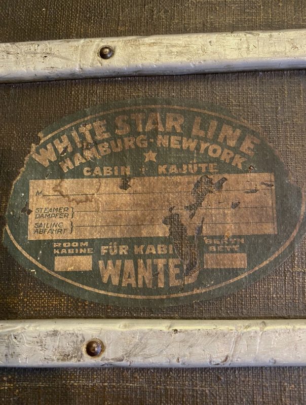 A White Star Line label reading Wanted, meaning the trunk traveled in the cabin