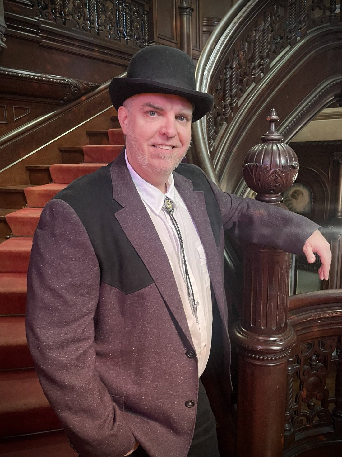 Dirk Strangely in 1912 dress on the staircase
